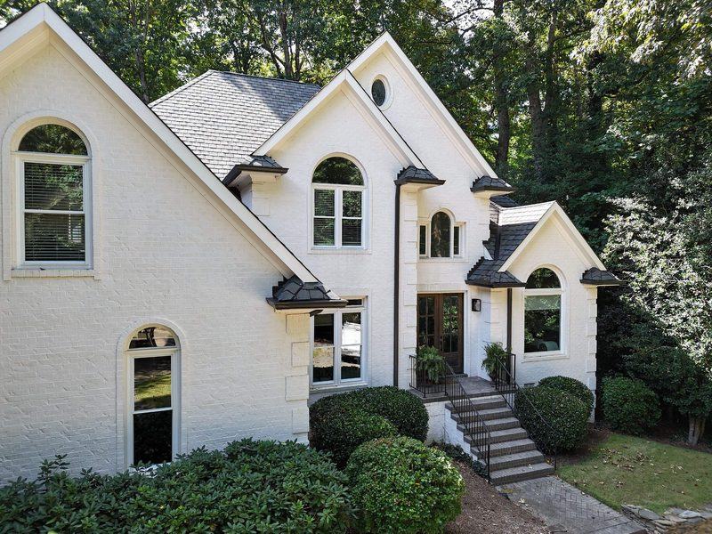 Home with new seamless gutters and downspouts installed by Cadmus Construction in Raleigh, NC