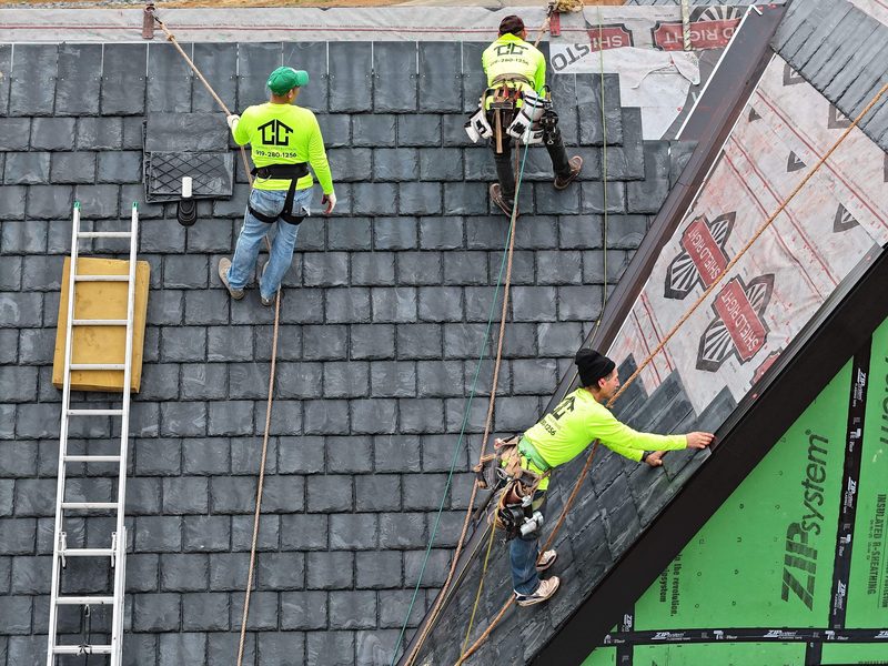 Cadmus crew installing a resilient synthetic slate roof over sealed underlayment